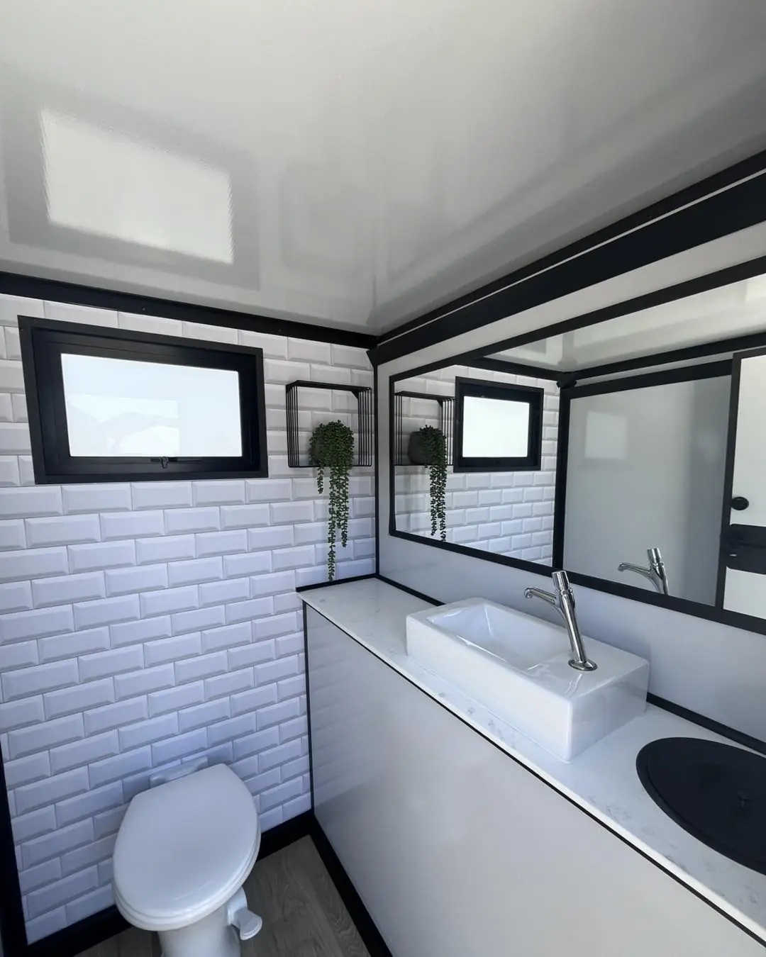 Restroom trailer interior: flush toilet and vanity