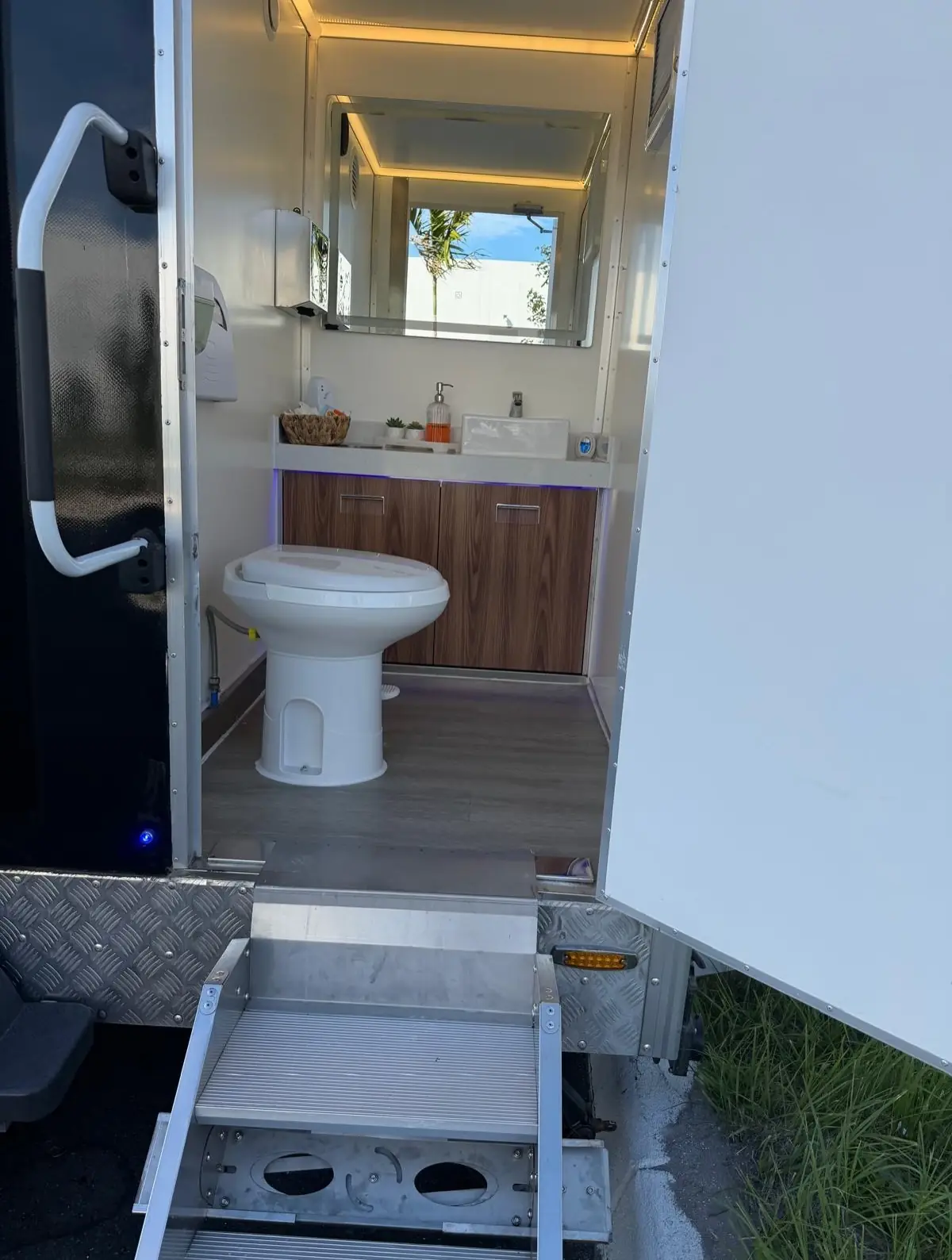 Wood vanity inside a restroom trailer