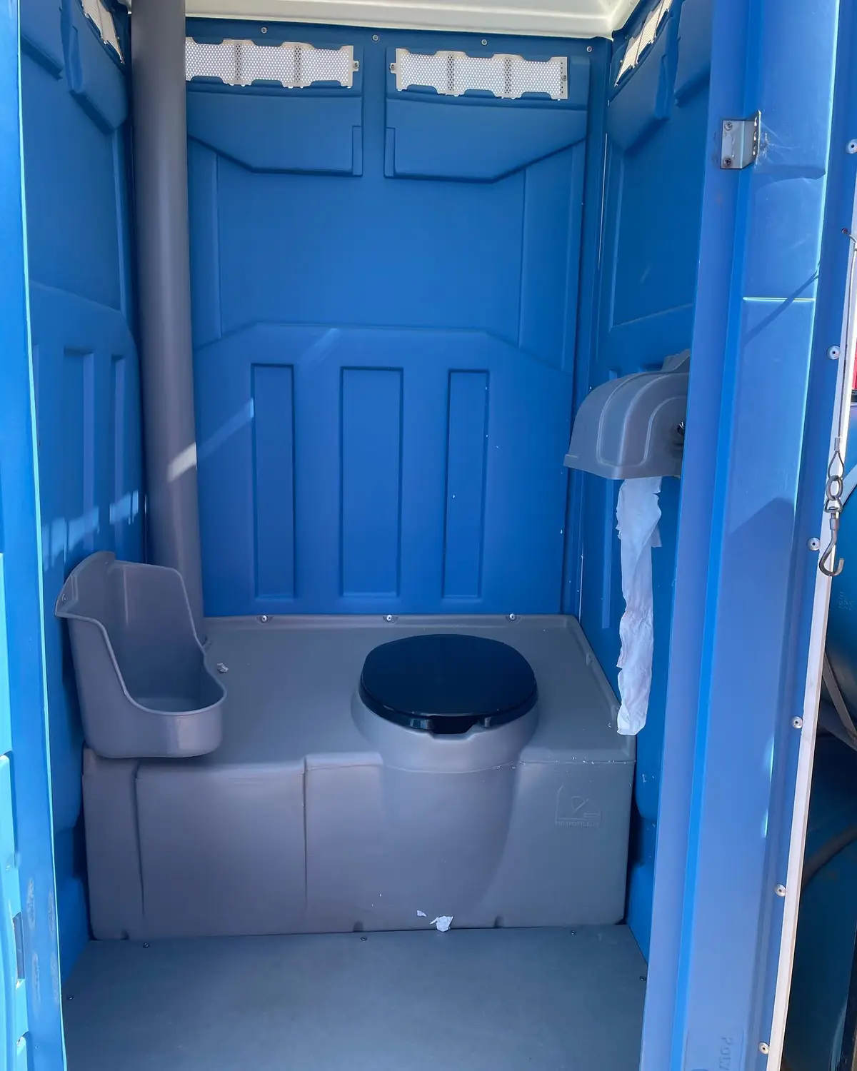 Inside a blue standard porta potty