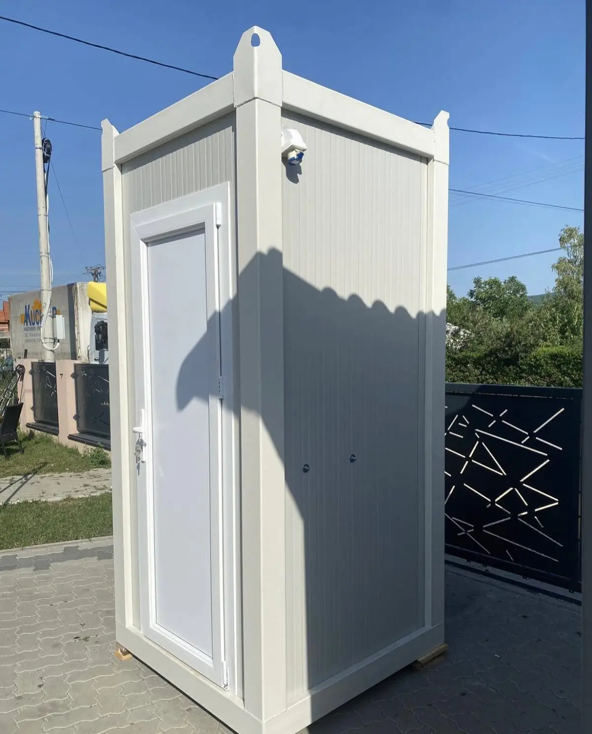 White VIP flushing restroom cabin on firm ground